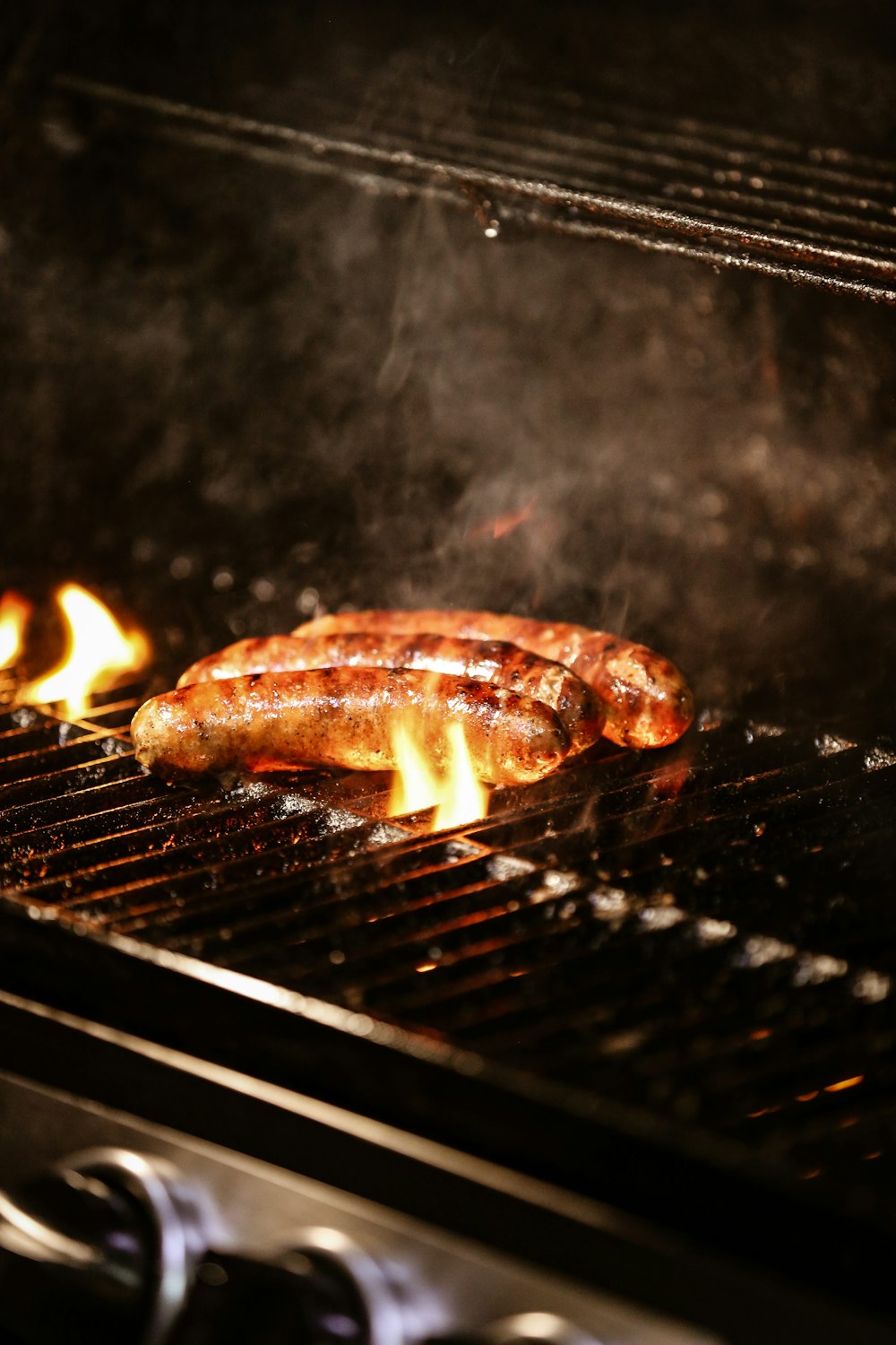 a hot dog is cooking on a grill