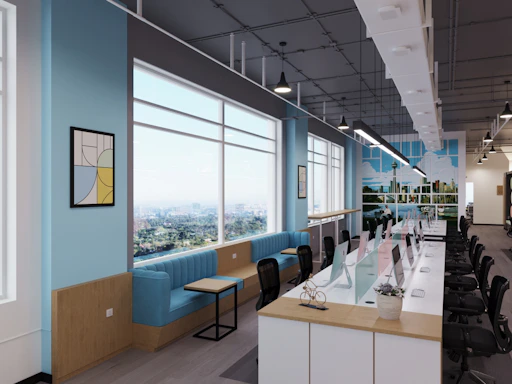 Bright, modern co-working space with desks and comfortable seating.