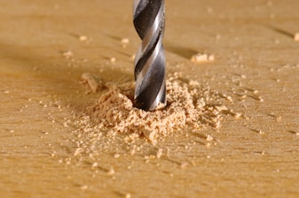a drill being used to drill a piece of wood representing sex