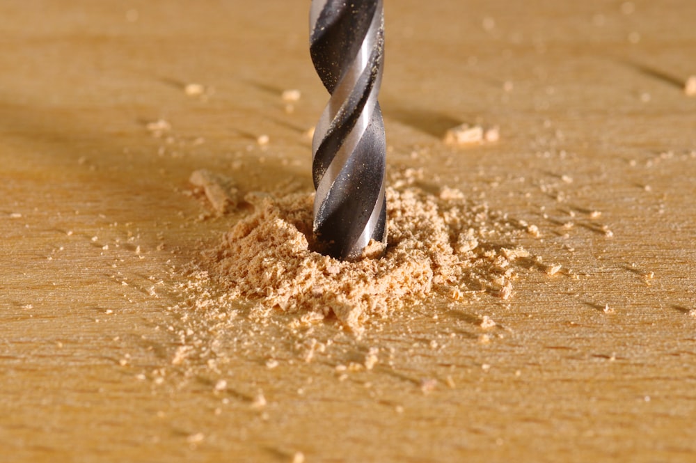 a drill being used to drill a piece of wood