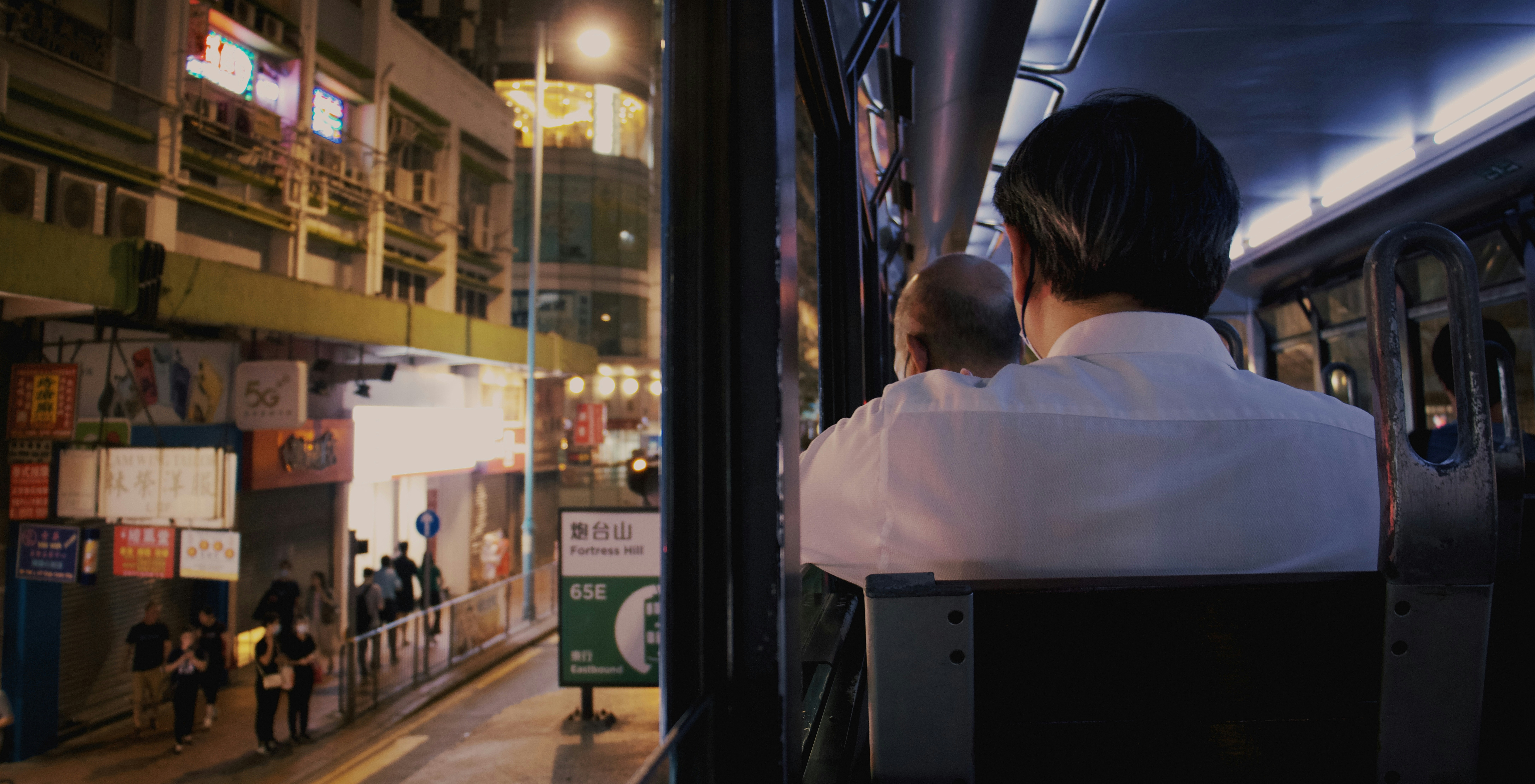 Man on a bus looking out the window