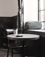 A cozy corner with a stylish organizer and a cup of coffee on a wooden table.