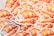 A stack of adorable stickers features a whimsical illustration of a fluffy white dog wrapped in a flaky croissant with strawberries and small star decorations. The artwork combines bright, warm colors and playful elements, creating a cozy and charming aesthetic.