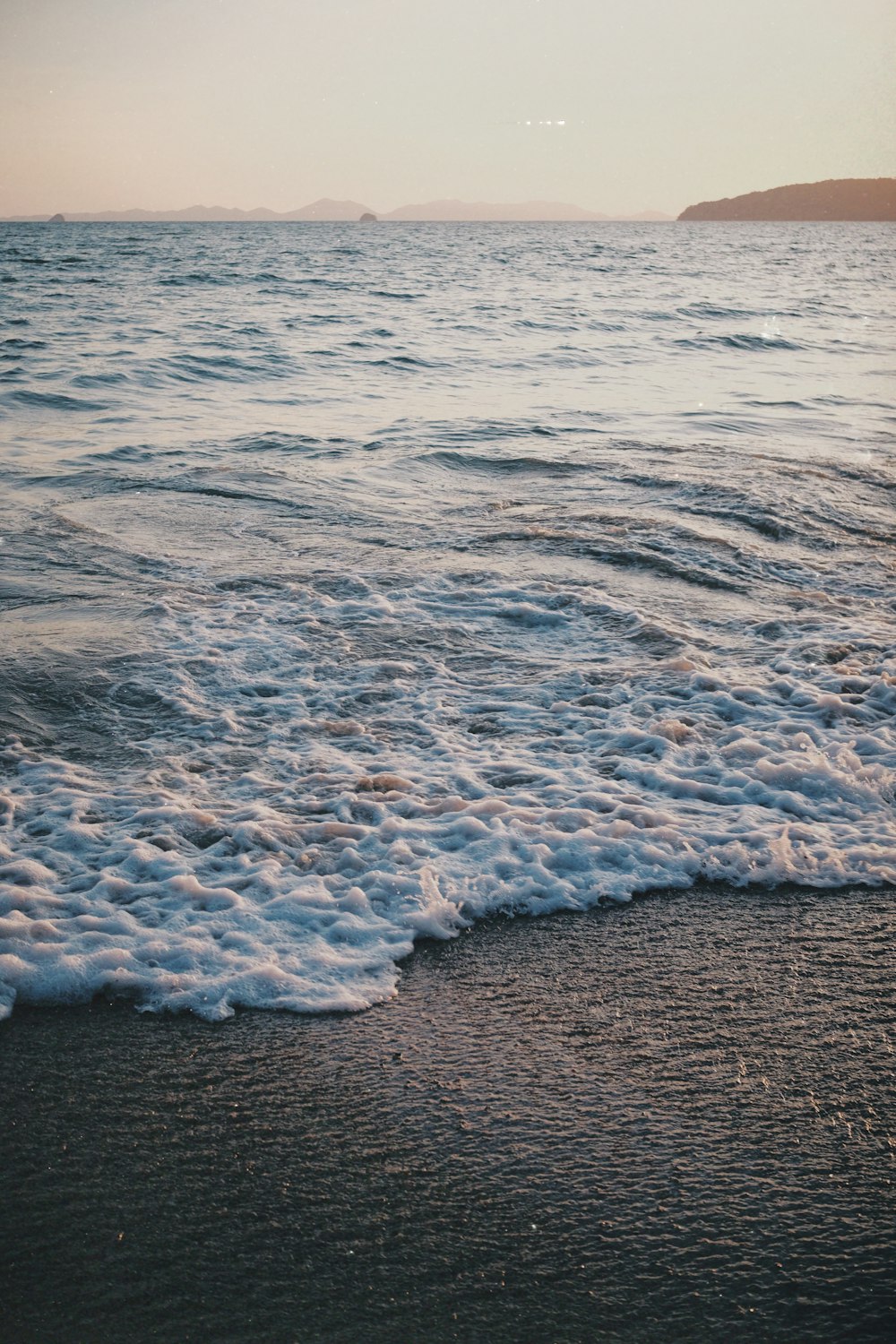 a beach with waves coming in to shore