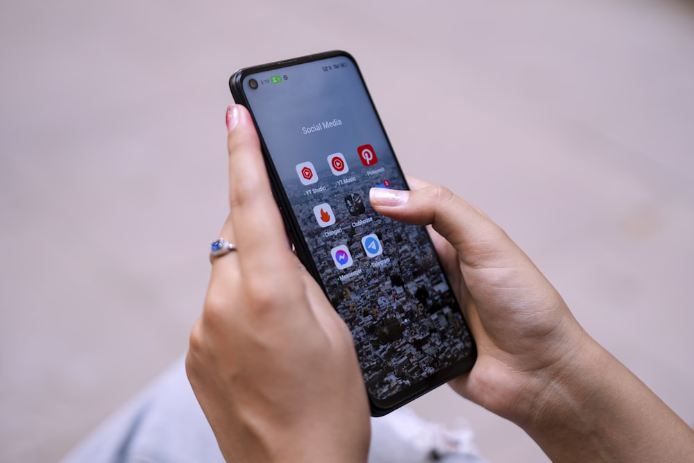 a woman holding a cell phone in her hand