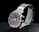 A sleek wristwatch with a stainless steel band featuring gold accents. The watch face combines dark and light elements in a sophisticated design, showcasing several subdials with gold hands and markers. The brand name is visible on the face, adding to its luxurious appeal.