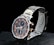 A sleek wristwatch with a stainless steel band featuring gold accents. The watch face combines dark and light elements in a sophisticated design, showcasing several subdials with gold hands and markers. The brand name is visible on the face, adding to its luxurious appeal.