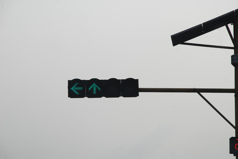 a traffic light with a green arrow on it