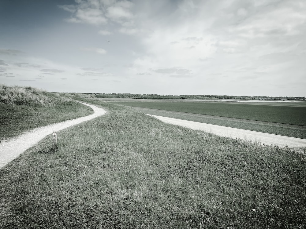 a black and white photo of a dirt road