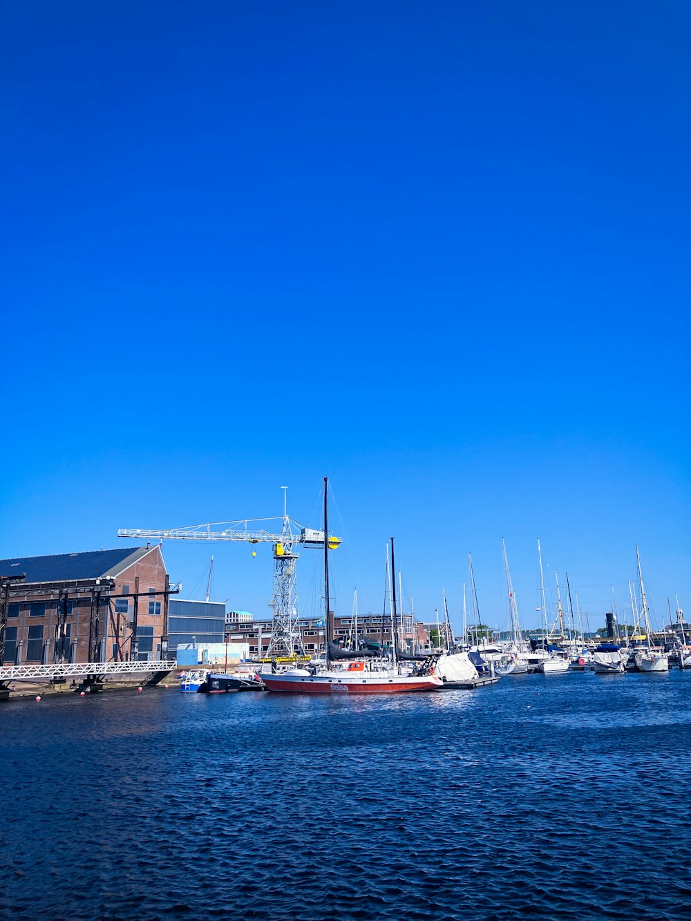 a harbor filled with lots of boats under a blue sky