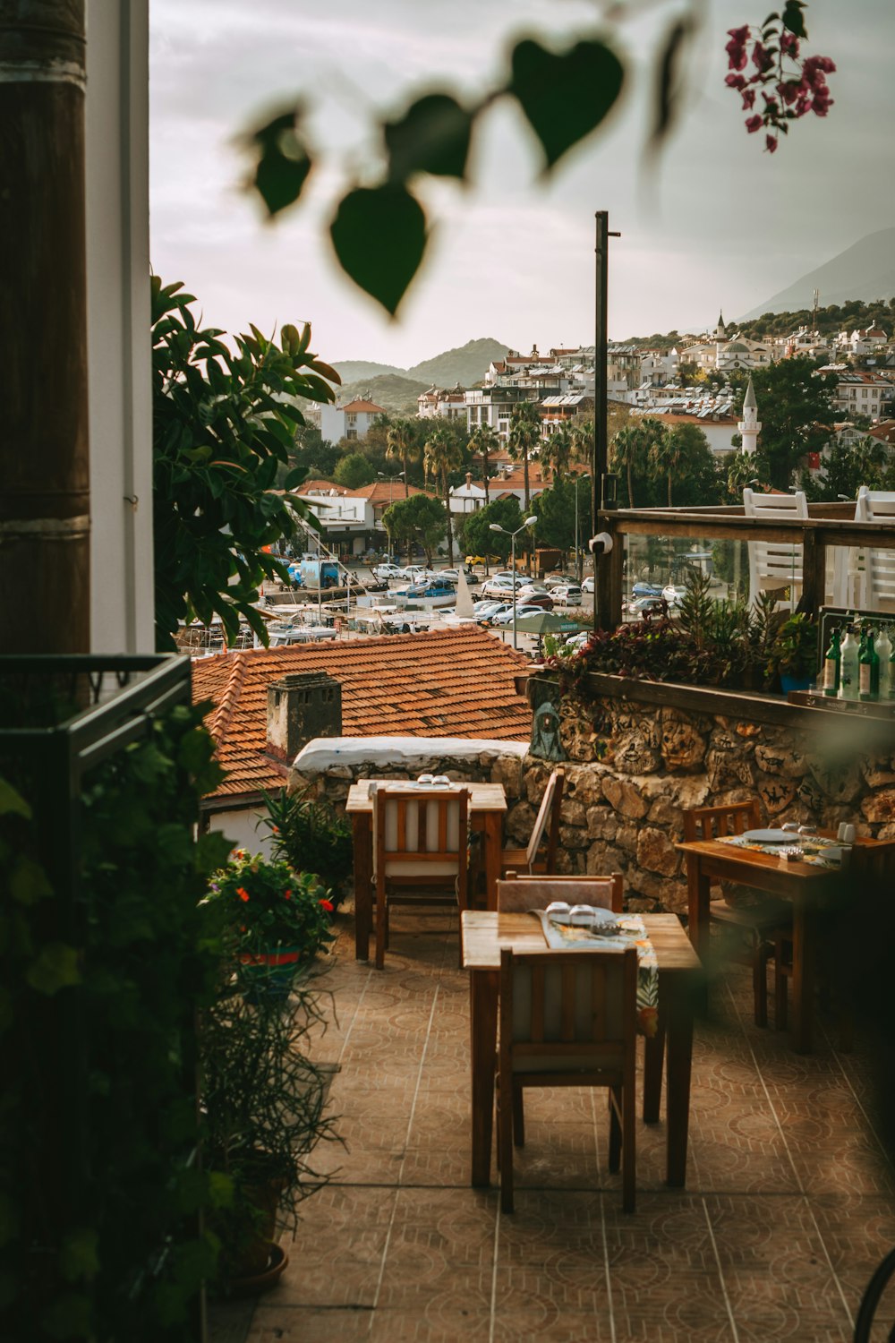 a patio with tables and chairs and a view of a city