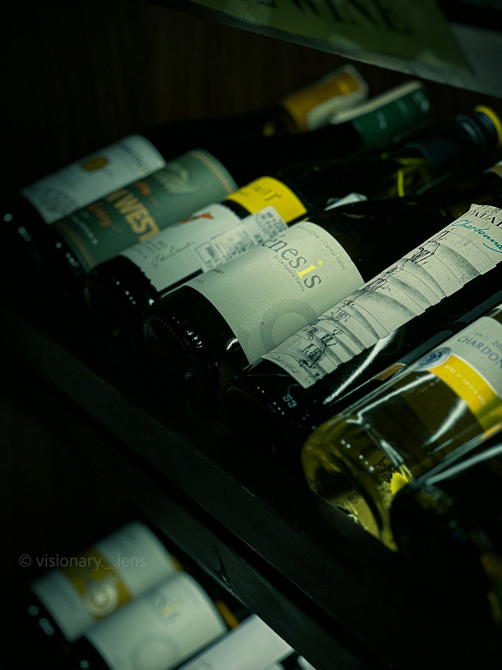 several bottles of wine are lined up on a shelf