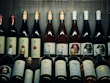 Bottles of organic wine arranged on a wooden shelf with vineyard scenery in the background