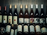 A collection of various wine bottles on a wooden table.