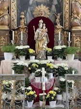 A serene altar decorated with flowers and candles honoring Mãe Oxum.