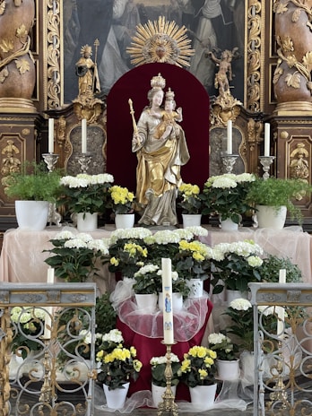 A serene altar decorated with flowers and candles honoring Mãe Oxum.