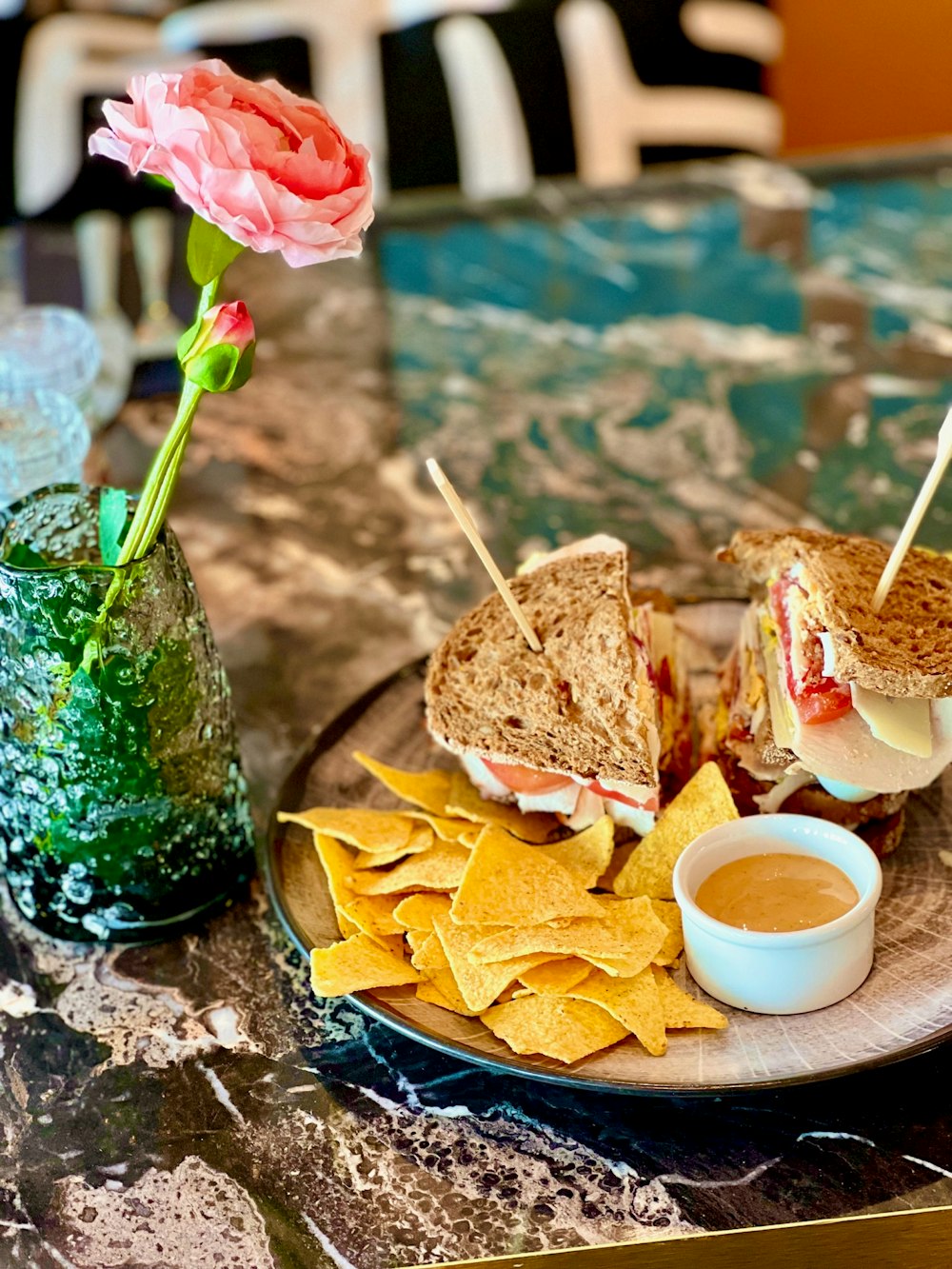 a plate with a sandwich and chips on a table