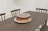 A beautifully decorated chocolate cake on a rustic wooden table.