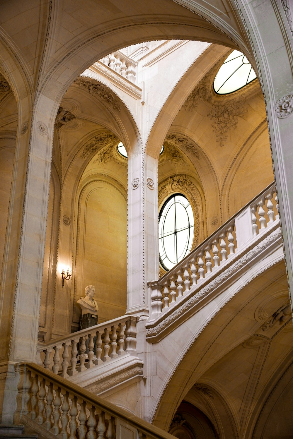 a staircase in a large building with arched windows