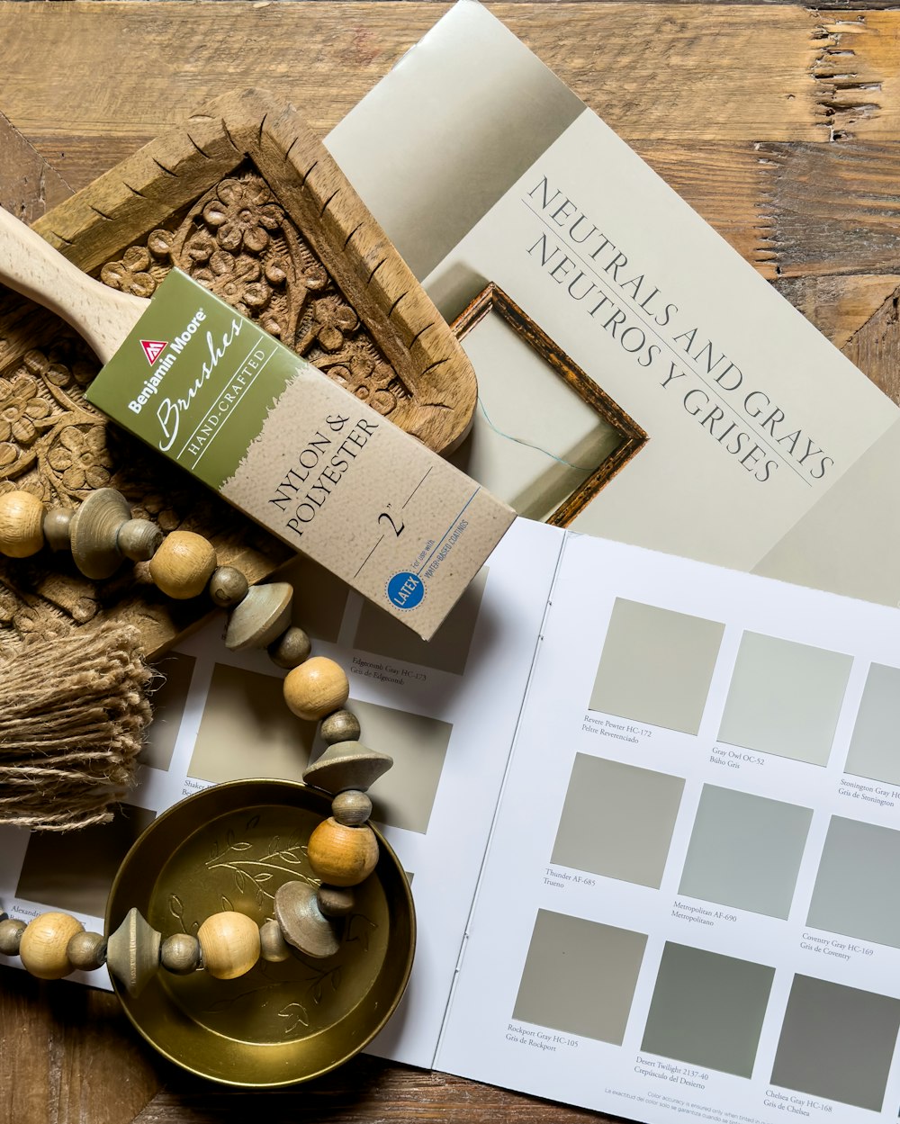 a wooden table topped with a book and a necklace