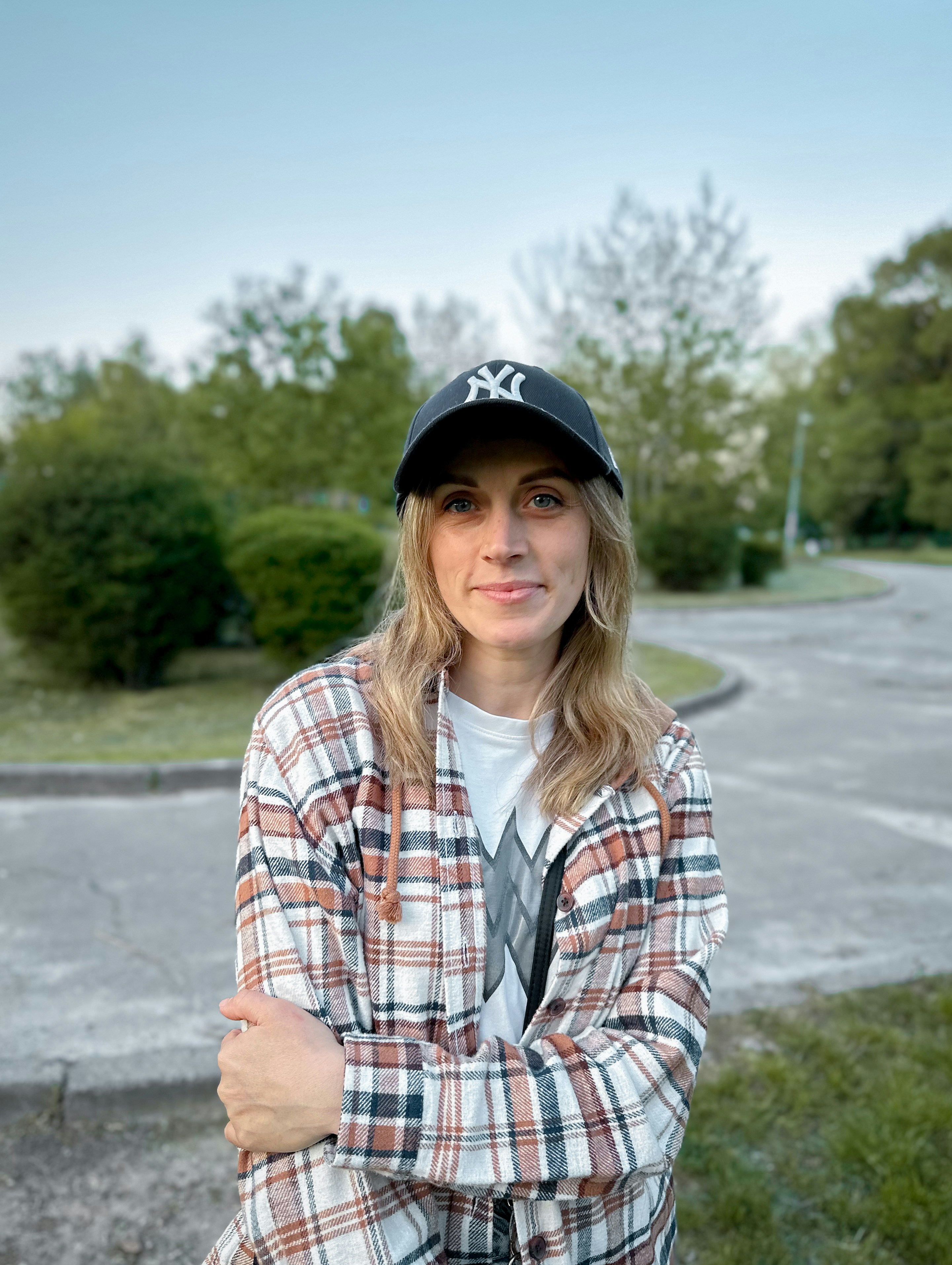 a woman wearing a hat and a plaid shirt