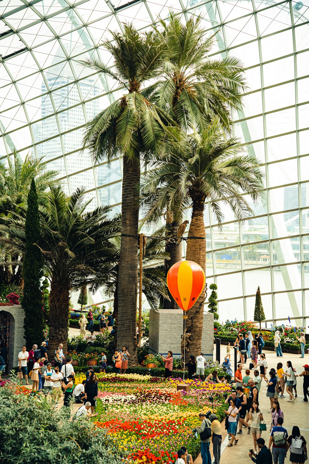 a group of people standing around a flower garden