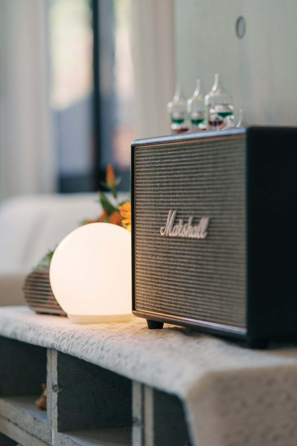 a radio sitting on top of a table next to a lamp