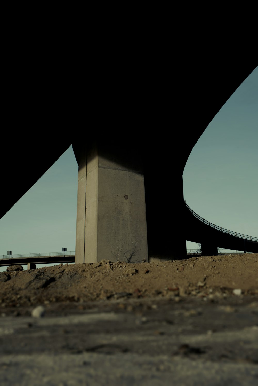 the underside of a bridge with a sky background