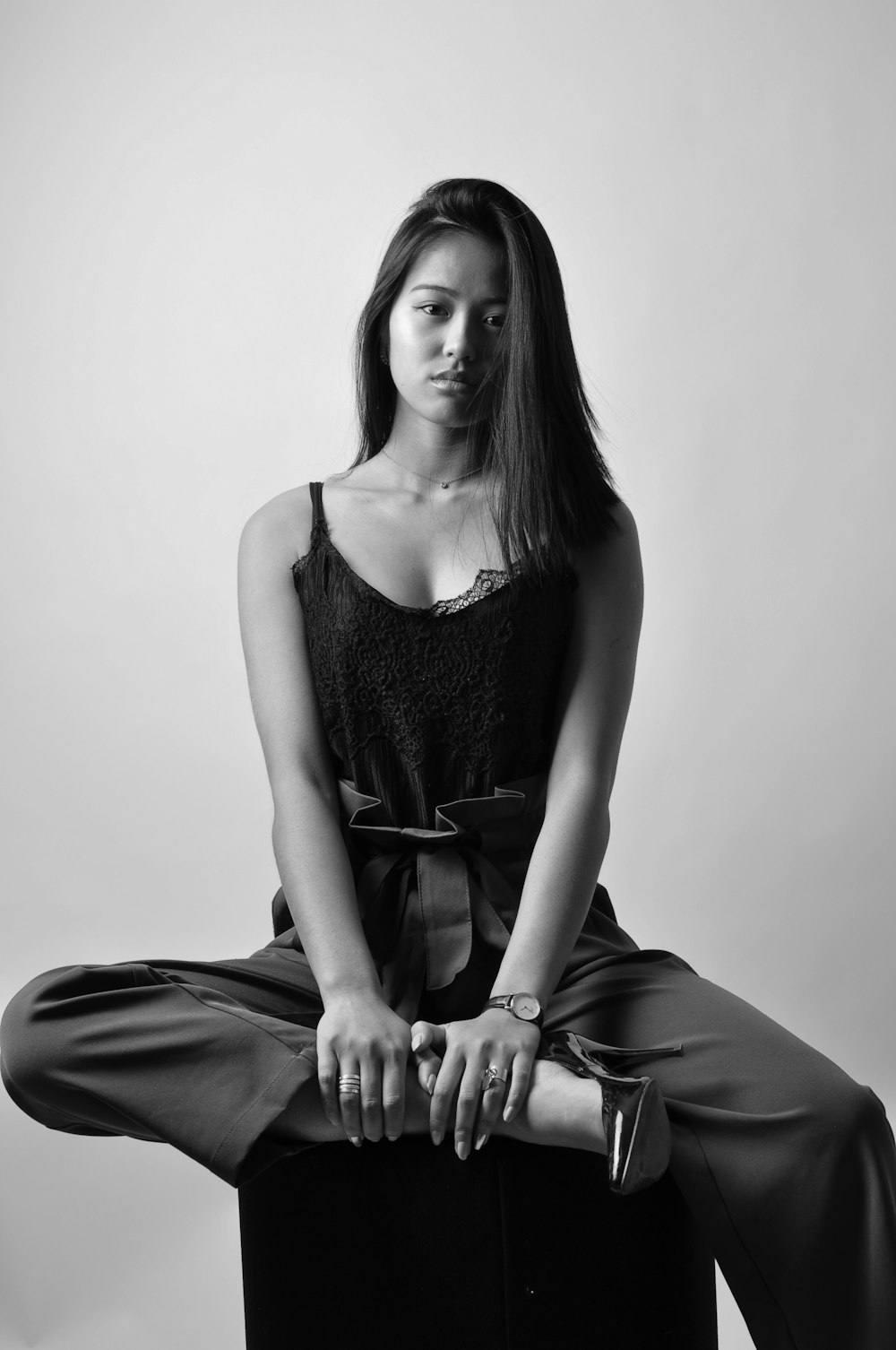 a woman sitting on top of a chair with her legs crossed