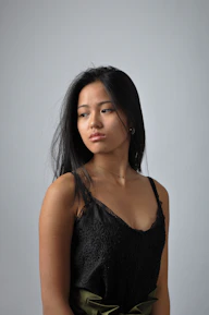 a woman in a black top is posing for a picture