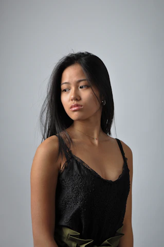 a woman in a black top is posing for a picture
