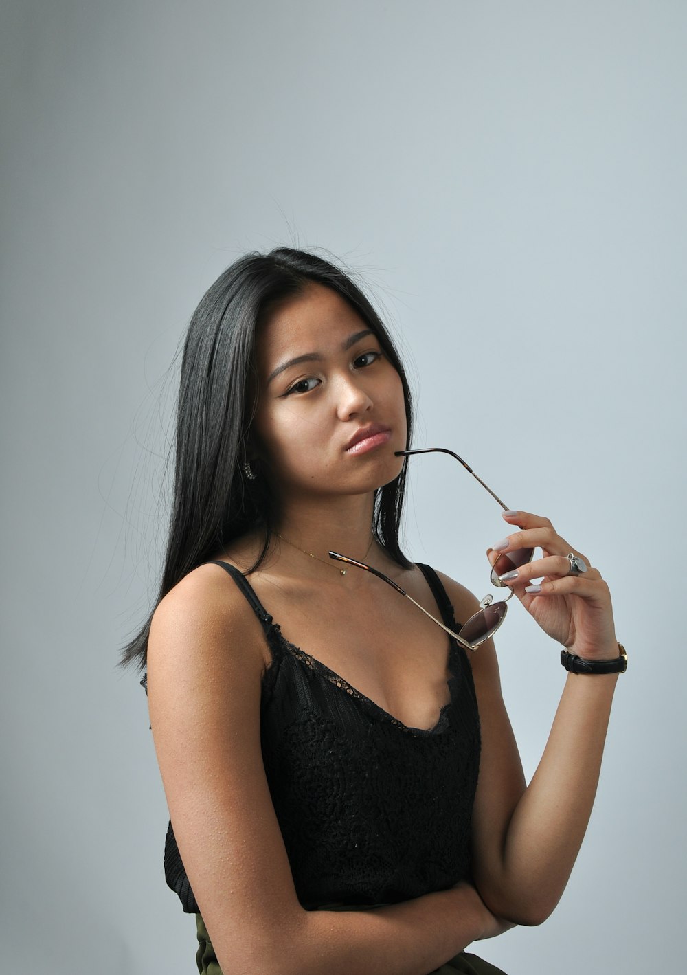 a woman in a black top holding a pair of scissors