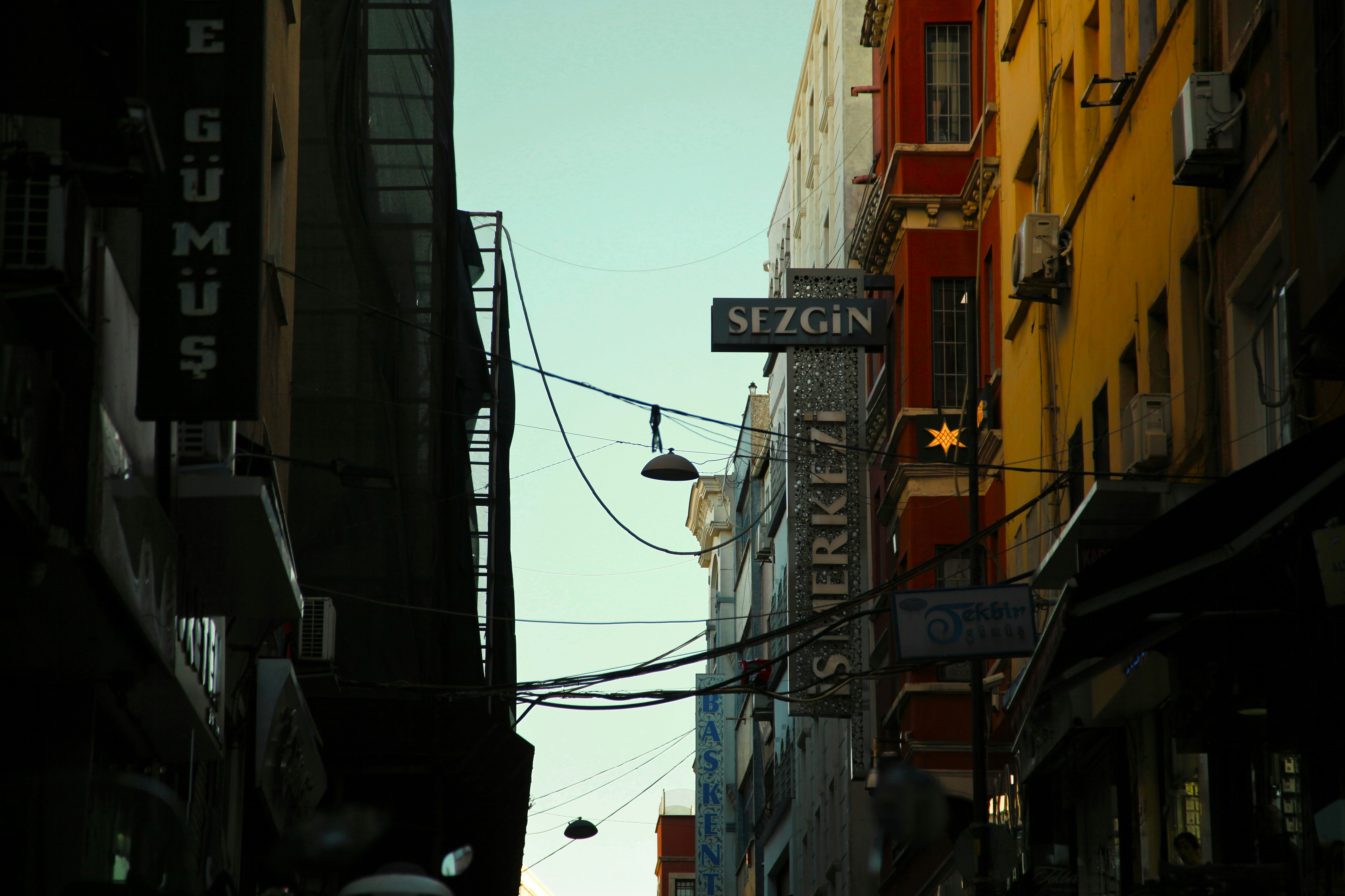 a street sign hanging from the side of a building