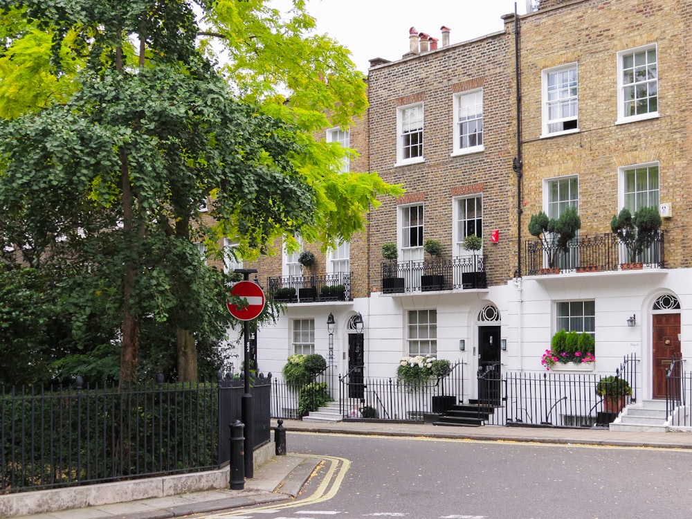 a street corner with a stop sign in front of a row of buildings