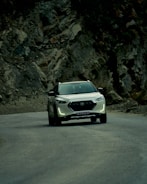 Dynamic profile of Hyundai Tucson navigating mountain road.