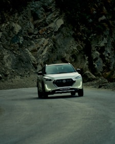 An adventurous SUV driving along a scenic mountain road.