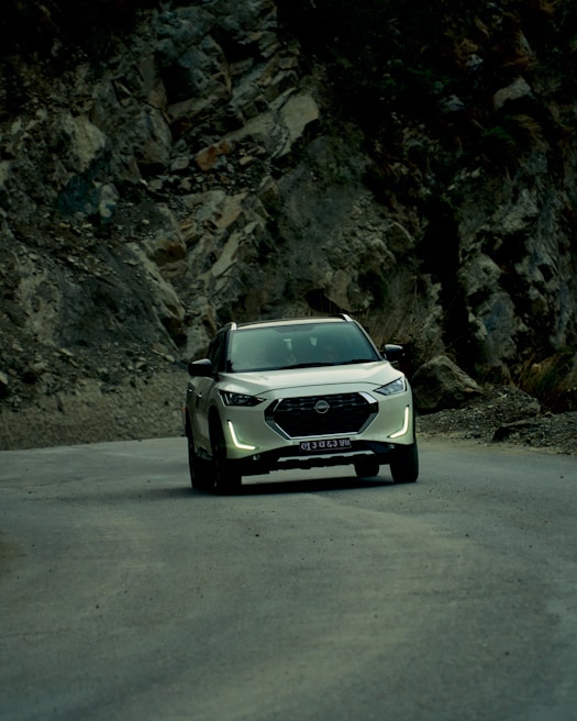 A spacious SUV driving along a scenic mountain road.