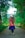 a woman with long hair walking down a dirt road