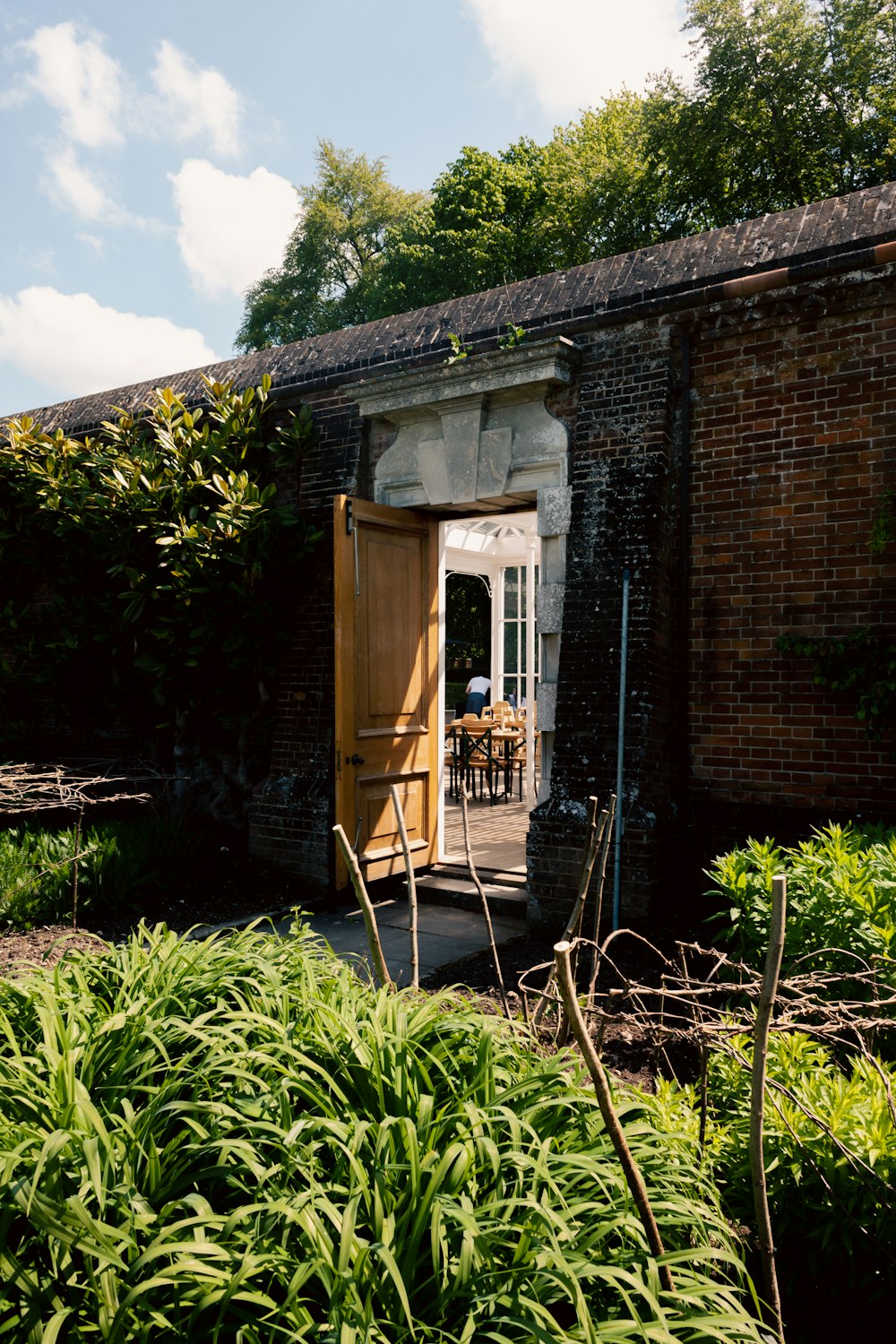 a brick building with a wooden door and window