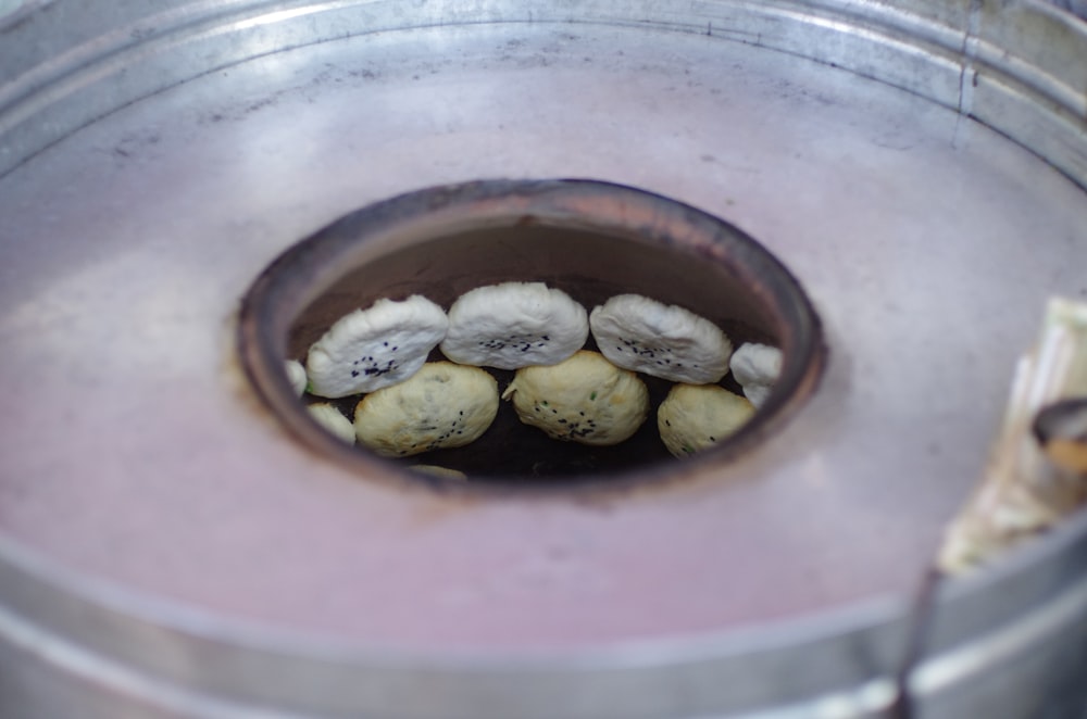 a group of mushrooms sitting inside of a metal container