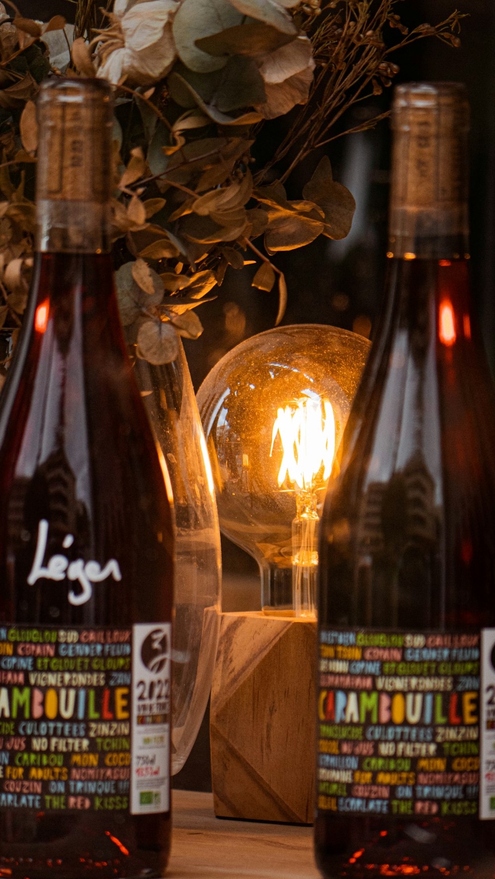 three bottles of liquid sitting on top of a table