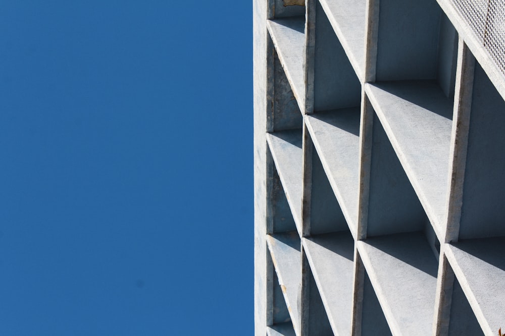 an airplane flying in the sky over a building