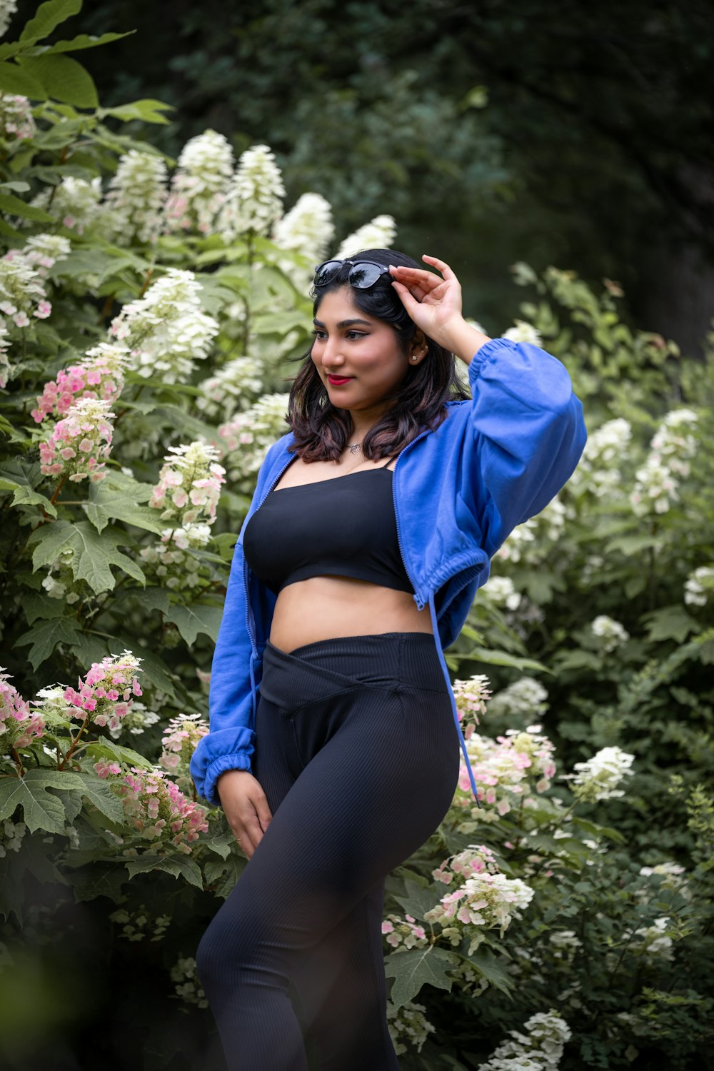 a woman in a crop top and leggings posing for a picture