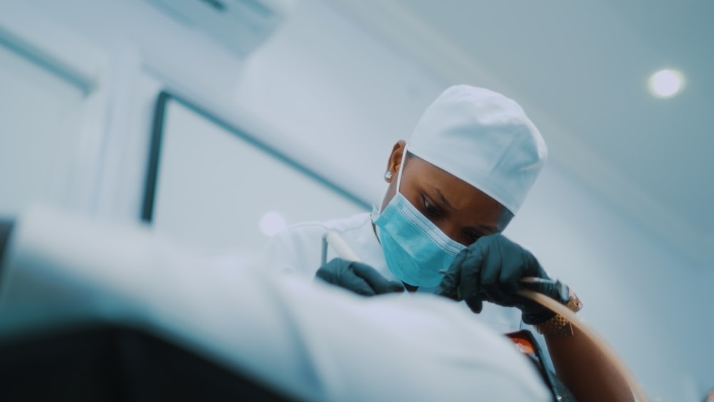 a person wearing a surgical mask and gloves