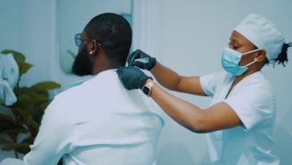 a woman getting her hair done by a man