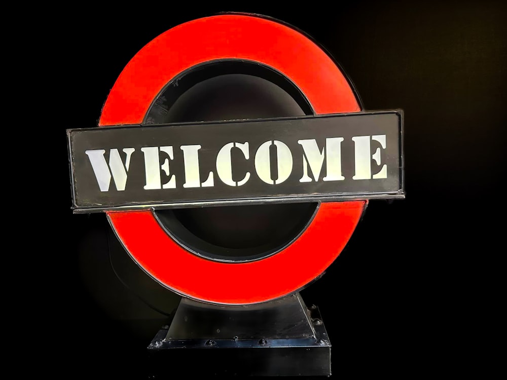 a red and black sign that says welcome
