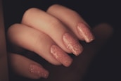 A close-up of beautifully manicured nails with vibrant nail polish.