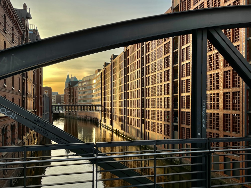 a bridge over a river next to tall buildings
