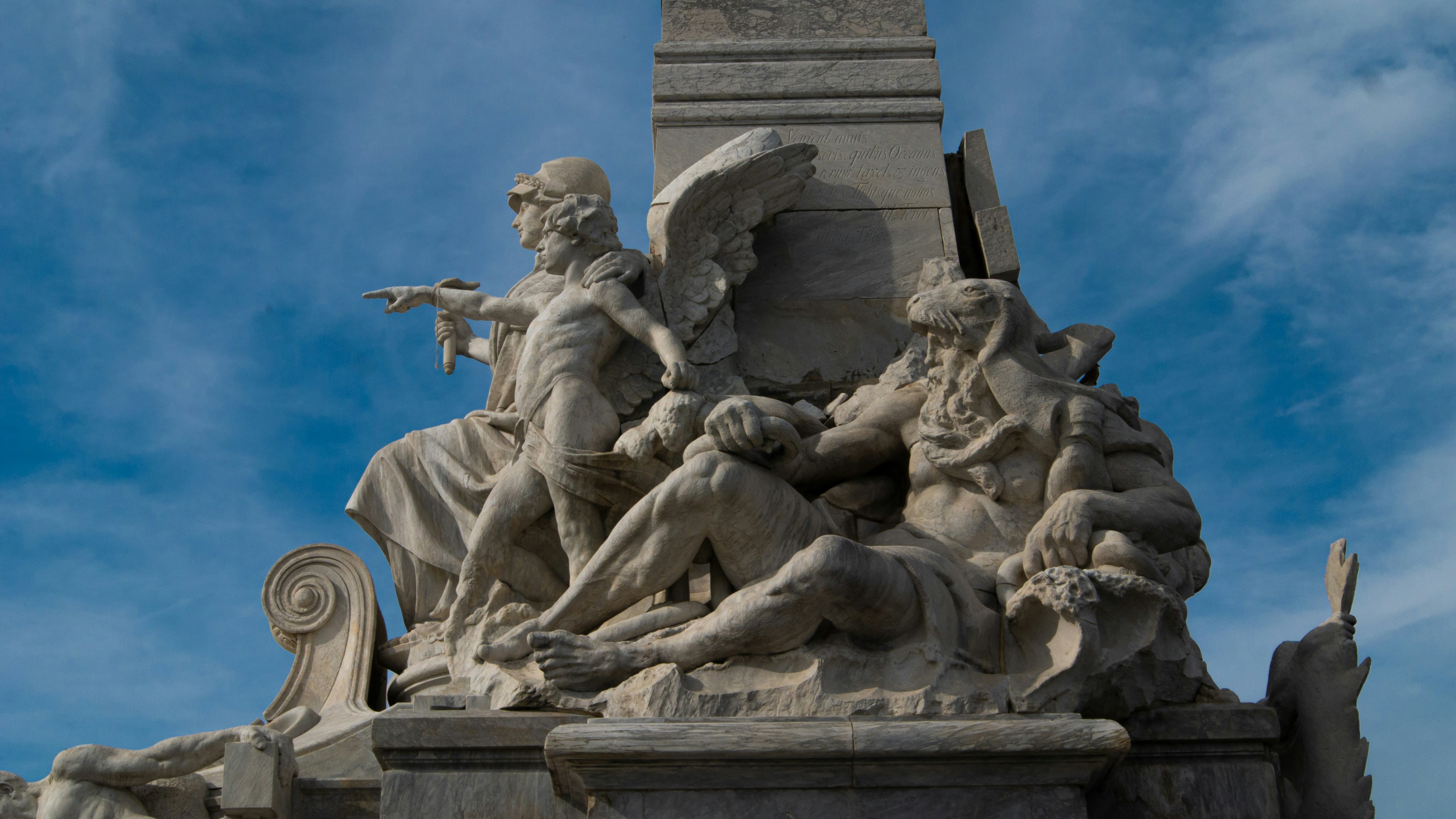 a statue of a man holding a gun in front of a blue sky, A statue honoring Christopher Columbus outside the regional airport of Buenos Aires, Argentina.