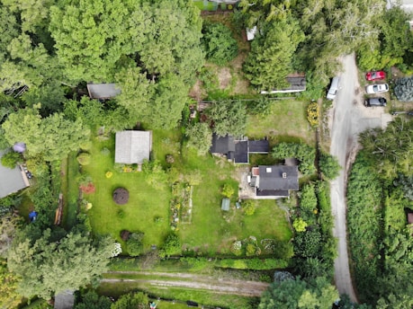 an aerial view of a home surrounded by trees